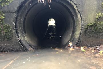 Culvert with flexible culvert baffles and flexible culvert weirs installed to improve fish passage