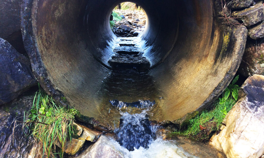 Culvert with flexible culvert baffles and flexible culvert weirs installed to improve fish passage